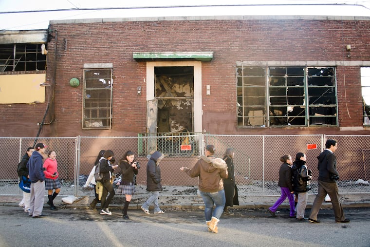 Students walk along a street in Fairhill, Philadelphia's poorest neighborhood according to census data. A new study found that youth suicide rates rise with poverty rates. (Richard Kauffman / Staff Photographer)