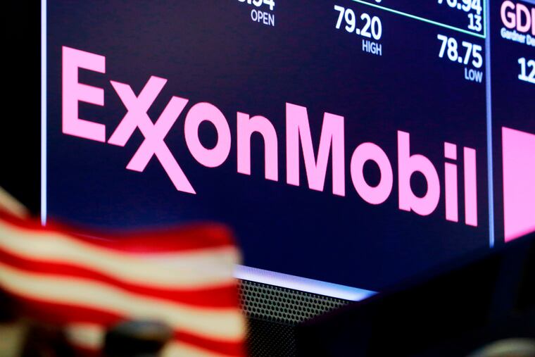 In this April 2018 photo, the logo for ExxonMobil appears above a trading post on the floor of the New York Stock Exchange.