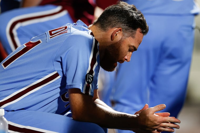 Phillies pitcher Ian Kennedy looks at his hands in the dugout after getting replaced in the ninth inning against the Colorado Rockies on Thursday.