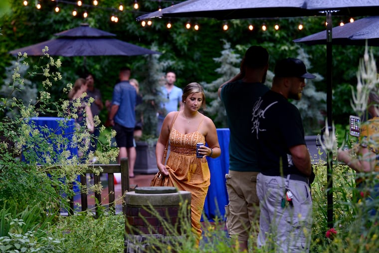 Patrons enjoy cocktails during a pop-up beer garden event at the Mutter Museum early this month.