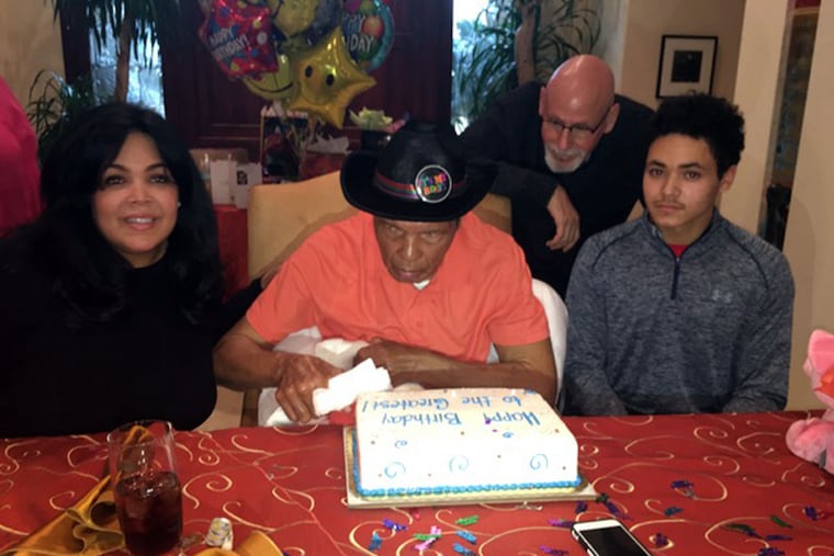 Family snapshot of daughter Khaliah, her husband Spencer (standing) and son Jacob celebrating one of Muhammad Ali's last birthdays.