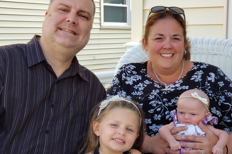 Eric and Rebecca with daughters Olivia, left, and Kennedy.