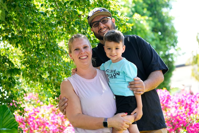 Alicia Celaya (left), David Cardenas (back), and their son Adrian, 3, at their home in Phoenix. Celaya and her family will lose their Medicaid coverage later this year.