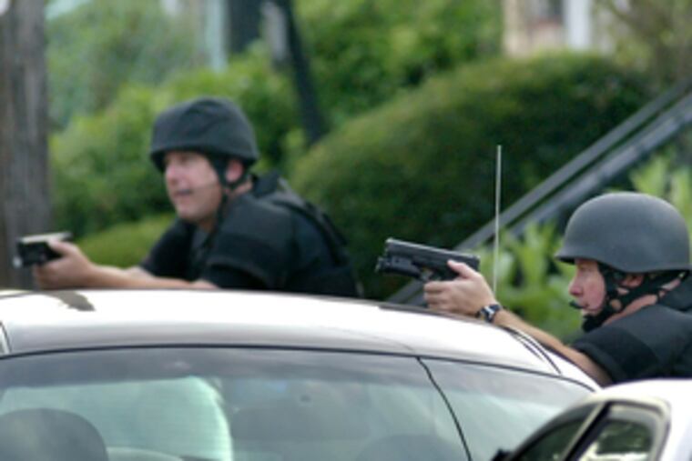 SWAT team positioned on Cedarhurst Street yesterday.