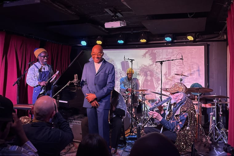 Sun Ra Arkestra bandleader Marshall Allen's 101st birthday celebration at Solar Myth in South Philadelphia on Sunday night, with Andre 3000 (left); Ronnie Boyd, who is Marshall Allen's son; and Allen, who is seated. Drummer Austin Williamson is in the background.
