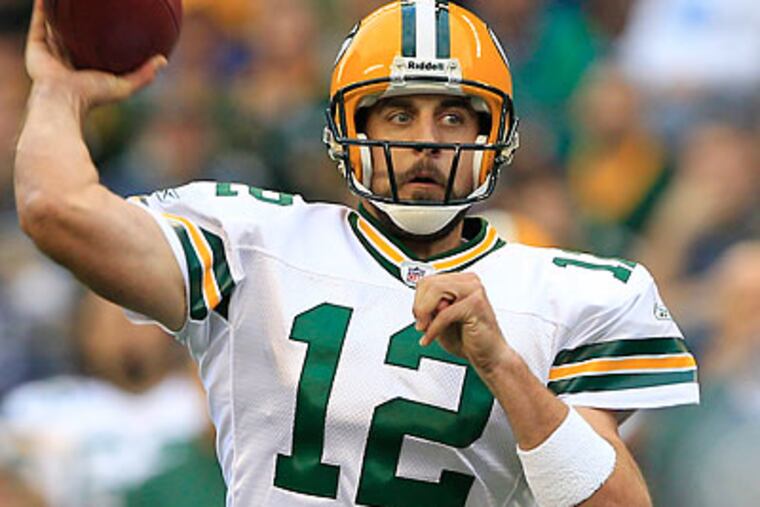 "We've definitely conversed more than once in the last few months," Aaron Rodgers said of Kevin Kolb. (Elaine Thompson/AP)