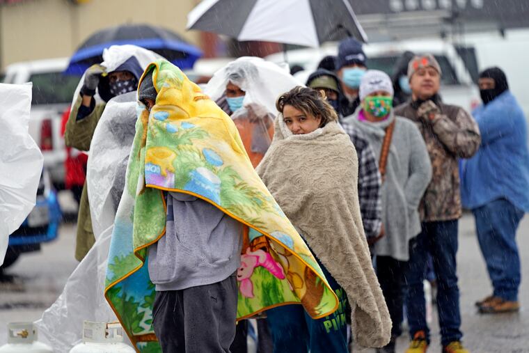 People waited in line to fill propane tanks Wednesday in Houston. Customers waited more than an hour in freezing rain to fill their tanks.