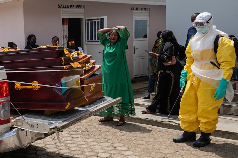 A woman mourns an Ebola victim as the coffin is take away for burial, at Sofepadi Hospital in Bunia, Congo, Saturday, May 23, 2026.