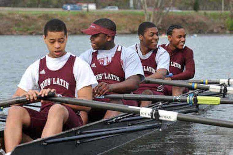 Out on the Schuylkill: Four Boys’ Latin of Philadelphia Charter School rowers — (from left) Jerell Maddrey, Brian Solomon, Eric Young, and Jared Smith — head for the start line at the April 19 Manny Flick regatta. Their boat, the Darth Vader, finished second in the race, their first competition.