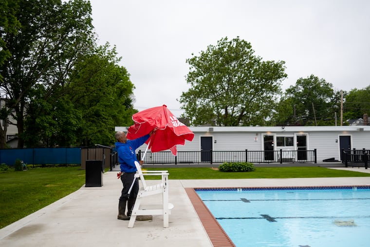 Anthony Patterson, 58, president of Nile Swim Club, sets up a lifeguard stand ahead of the club opening for the summer season.