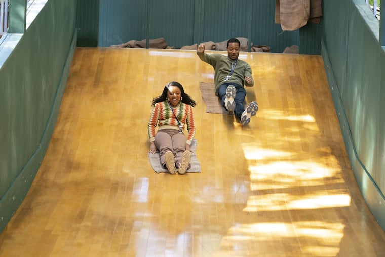 "Abbott Elementary" stars Quinta Brunson as Janine Teagues and Tyler James Williams as Gregory Eddie go down the made-for-TV replica of the Smith Playground slide.