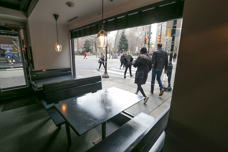 People were still out walking, but not eating or shopping on 18th near Walnut Street at 5 p.m. Monday. The coronavirus is hurting not only current but future retail in the city.