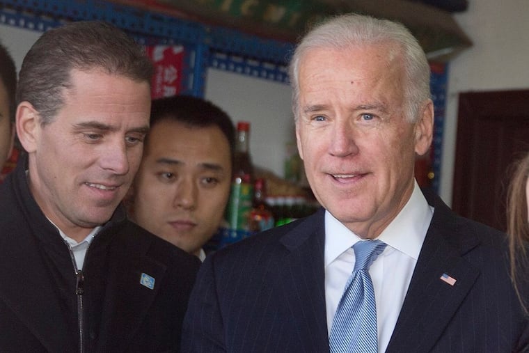 U.S. Vice President Joe Biden, right, buys an ice-cream at a shop as he tours a Hutong alley with his son Hunter Biden, left on Dec. 5, 2013 in Beijing, China. An impeachment inquiry stands to hurt Joe Biden's political career more than President Trump's, writes Marc Thiessen.