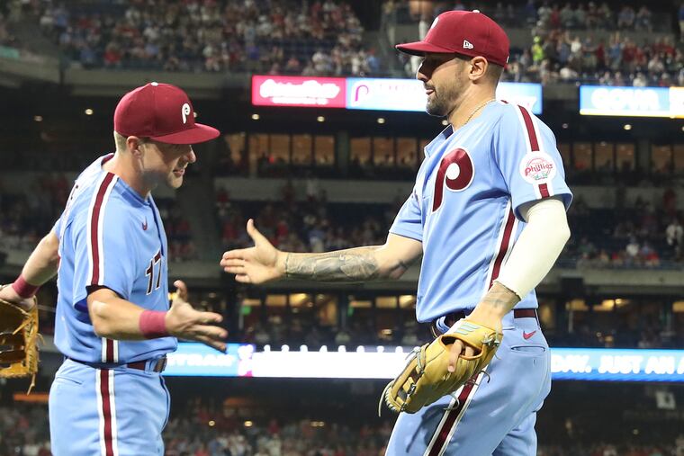 Nick Castellanos and Rhys Hoskins celebrate on Aug. 4 against the Washington Nationals. On Tuesday, the Phillies became the ninth team in MLB history to win 10,000 games.