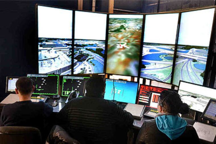 Atlantic Cape Community College students (from left) Sergio Gomez, Brandon Cooper, and Elaina Watson train at the new air-traffic control simulator at the Mays Landing campus. (Ben Fogletto / Atlantic City Press)