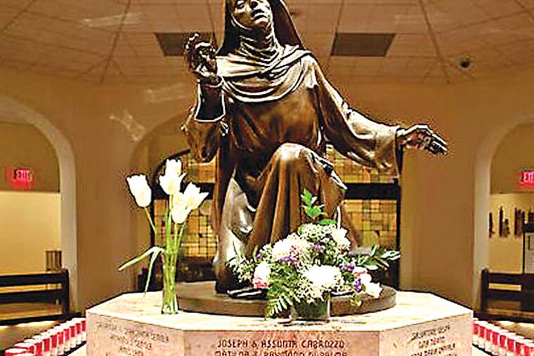 Saint Rita in adoration. In her hand she holds the thorn that was Christ's gift to her and in her silent surrender reminds us that Christ is to be the focus of our attention.