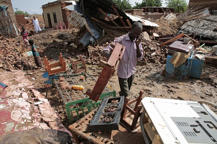 A man salvages items after heavy rainfall in the village of Aboud in the El-Manaqil district of the Al-Jazirah province, southeast of Khartoum, Sudan, on Monday.