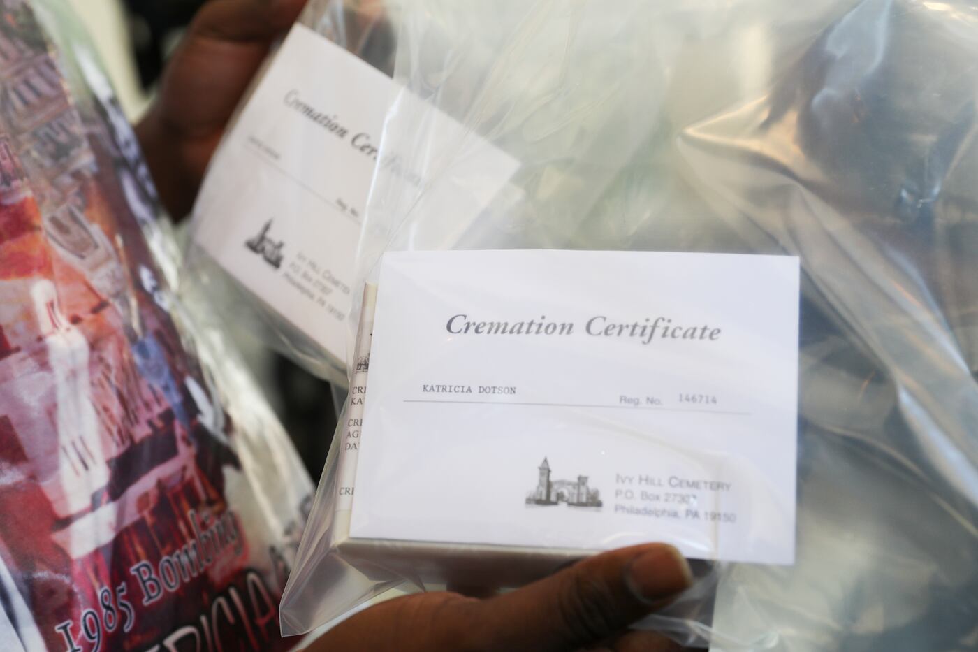 Lionell Dotson shows the certificates of the cremated remains of his two sisters, Katricia and Zanetta Dotson, who died in the MOVE bombing, at the Ivy Hill Cemetery and Crematory in Philadelphia on Aug. 3, 2022.