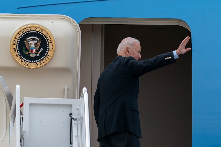 President Joe Biden waves as he boards Air Force One on Wednesday.