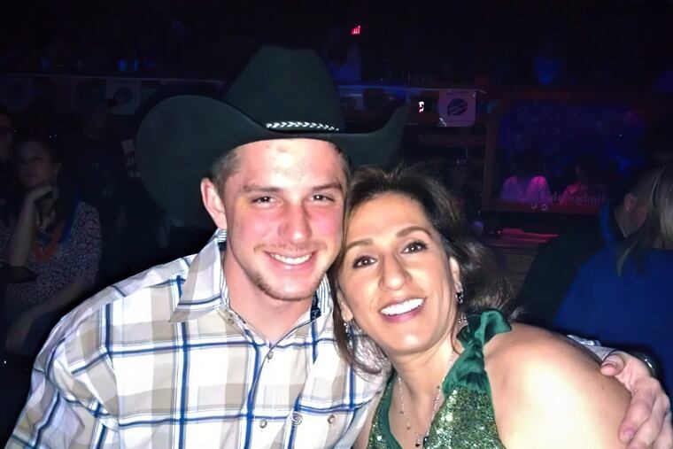 This image provided by Joey Reed shows Trevor Reed and his mom, Paula Reed, in 2014 in Arlington, Texas.