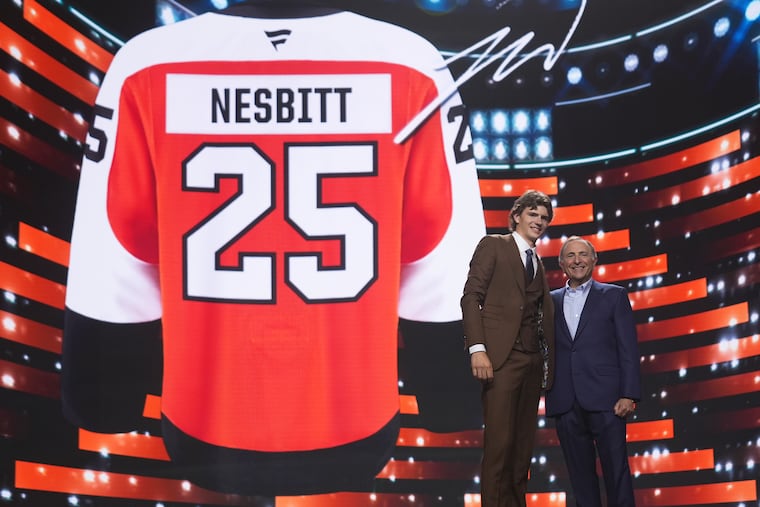 Jack Nesbitt, left, stands with NHL commissioner Gary Bettman after being drafted by the Philadelphia Flyers during the NHL hockey draft Friday, June 27, 2025, in Los Angeles.