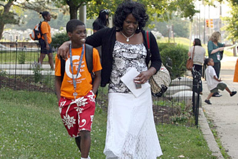 Creative Steps camper Jabriel Brown and his mother, Christine Pembleton, leave a meeting between parents of campers and lawyers at the Carnell Elementary School on Monday. The parents voted not to return to The Valley swim club. (Yong Kim / Staff Photographer )