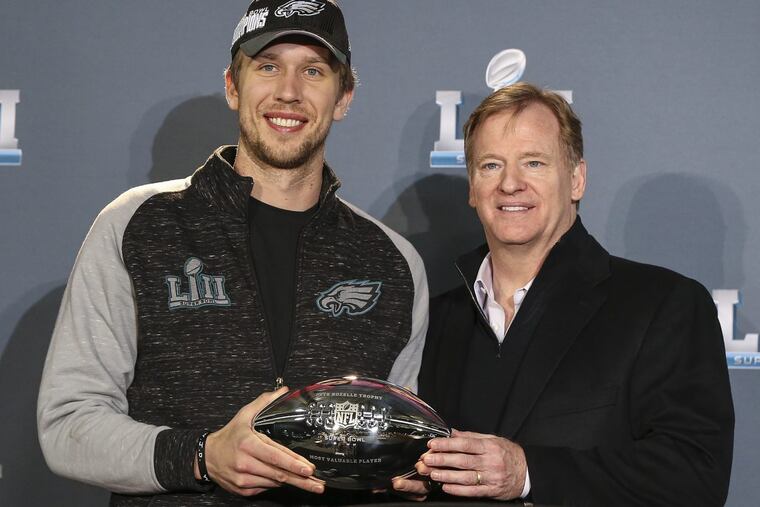 Eagles quarterback Nick Foles receives the MVP award from NFL commissioner Roger Goodell.