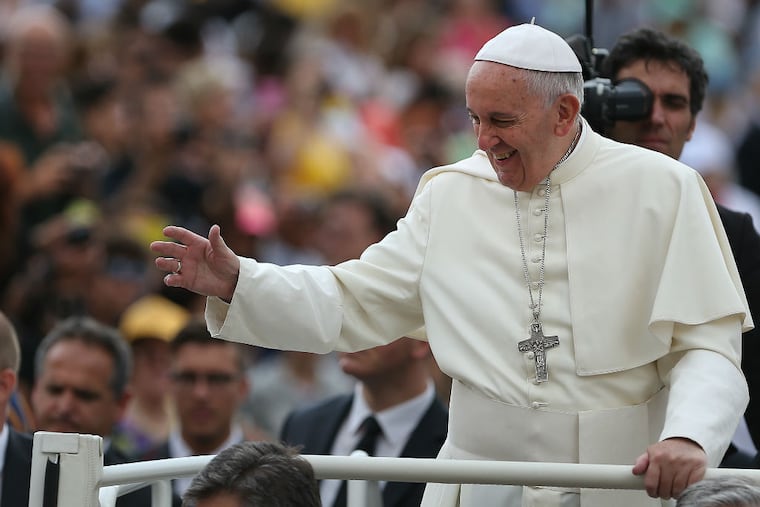 Pope Francis waves as he arrives in St Peter's Square at the Vatican for his weekly Papal Audience in Rome, Italy on June 24, 2015. (DAVID MAIALETTI / Staff Photographer)