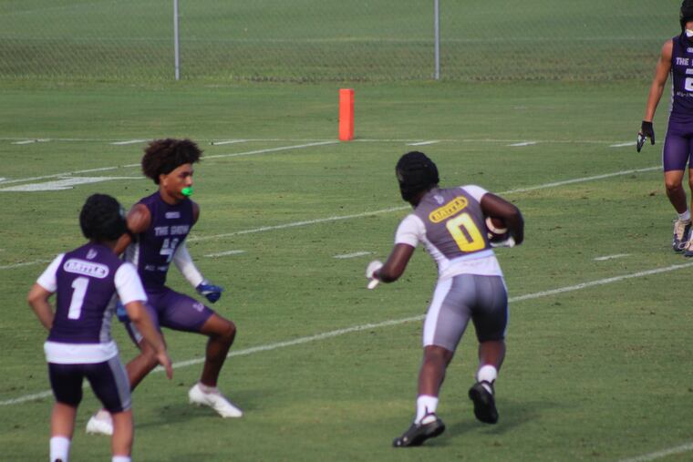 Jiaire Greene makes a catch and runs in his Crocs.