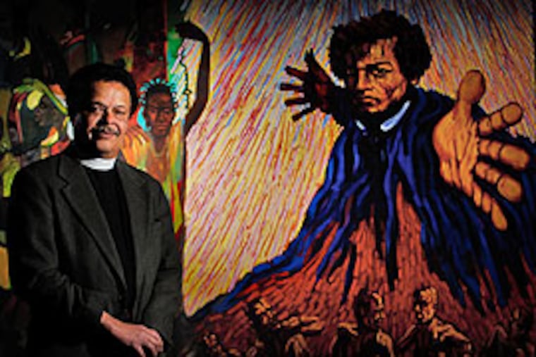 The Reverend Isaac Miller standing in front of at painting of Frederick Douglas on a wall of his church.