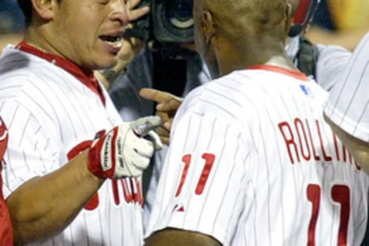 Carlos Ruiz celebrates winning home run with Jimmy Rollins.