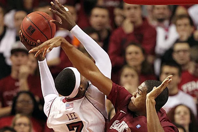 Saint Joseph's Ronald Roberts, Jr. fouls Temple's Anthony Lee in the first half. (Yong Kim/Staff Photographer)