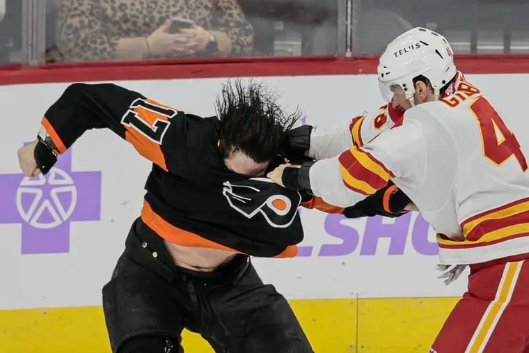 The Flyers' Zack MacEwen fights the Flames' Dennis Gilbert during the first period Monday at the Wells Fargo Center.