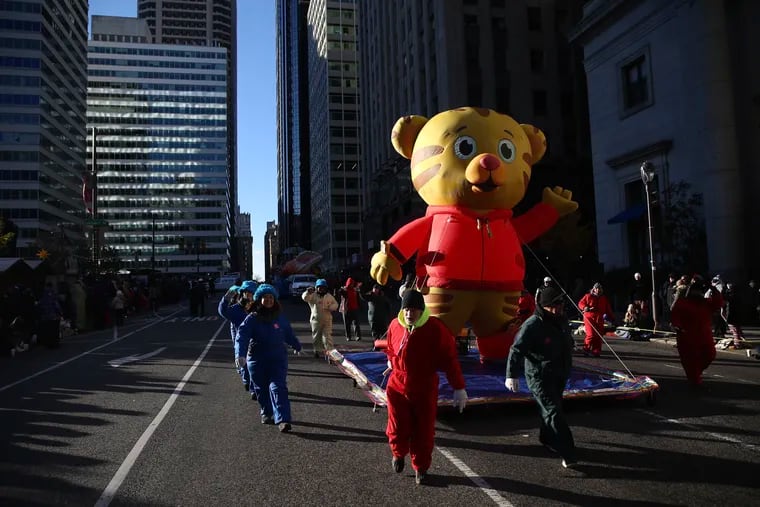 Workers pull the Daniel Tiger balloon during the Thanksgiving Day parade in Center City last year. Broadcast networks should fund public broadcasting to support children shows like PBS' "Daniel Tiger's Neighborhood," writes Rutgers' Amy B. Jordan.