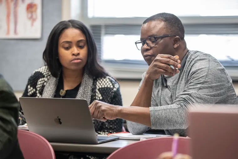 Level 1 nursing students Kiara Boyd (left) and Olu Atilade work together to complete their class assignment at the one-year nursing school at Eastern Center for Arts and Technology.
