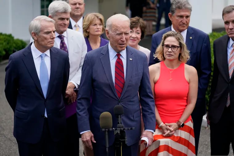 President Joe Biden, with a bipartisan group of Senators, speaks Thursday outside the White House in Washington.