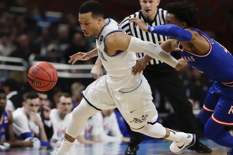 Villanova guard Jalen Brunson gets fouled chasing the basketball against Kansas guard Devonte’ Graham during the second half of the Wildcats’ win on Saturday.