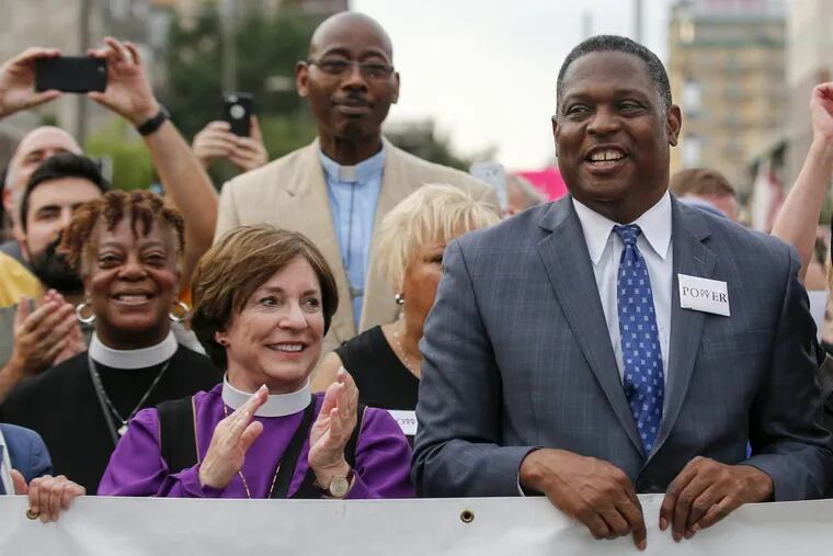 The Rev. Gregory Holston (right) of POWER stands next to Bishop Claire Burkat of the Southeastern Pennsylvania Synod of the Evangelical Lutheran Church in America during the “Philly Is Charlottesville” demonstration in Philadelphia.