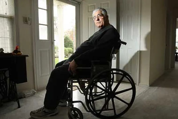 Phil Venuzio sits in his wheelchair in his home as he battles to find a way to deal with an illness. He's lost his job and his healthcare insurance. (Michael Bryant / Staff Photographer)