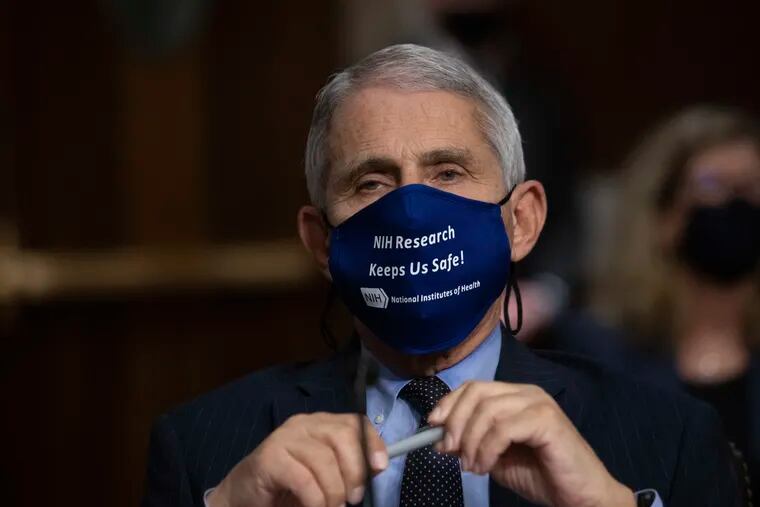 In this Sept. 23, 2020 file photo, Dr. Anthony Fauci, Director of the National Institute of Allergy and Infectious Diseases at the National Institutes of Health, listens during a Senate Senate Health, Education, Labor, and Pensions Committee Hearing on the federal government response to COVID-19 Capitol Hill in Washington.  Fauci is recommending masks at Thanksgiving gatherings if the coronavirus status of people is unknown.  (Graeme Jennings/Pool via AP)