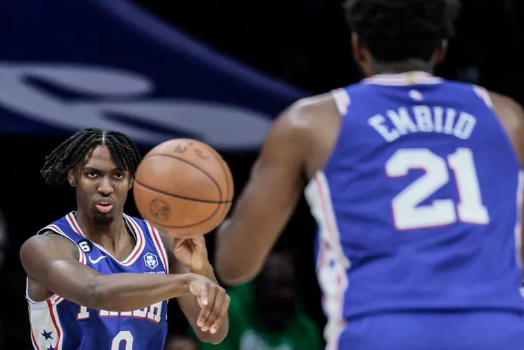 The Sixers' Tyrese Maxey throws a pass to teammate Joel Embiid while playing a game against the Indiana Pacers.