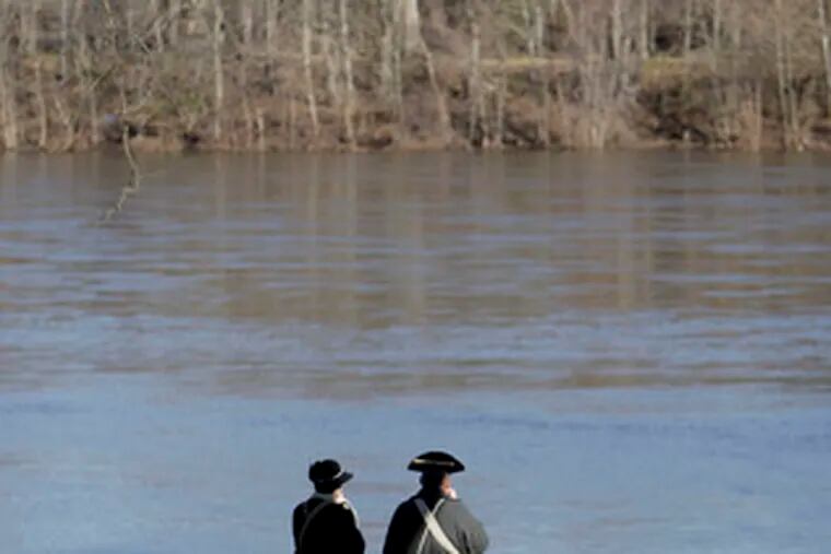 Reenactors contemplate the swift current of the Delaware. It was the second consecutive year conditions prevented a crossing.