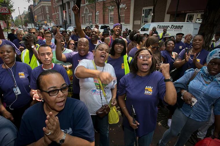 Members of 32BJ SEIU, the Service Employees International Union, gather at a rally on Locust Street. Negotiations on a new contract have begun. (ALEJANDRO A. ALVAREZ/Staff Photographer)