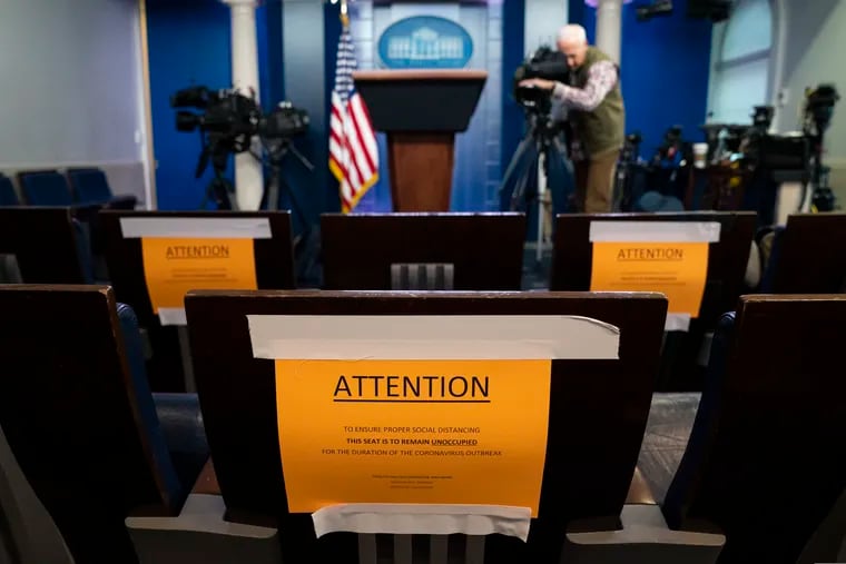 Signs in the briefing room of the White House indicate social distancing measures being taken to separate reporters working at the White House.