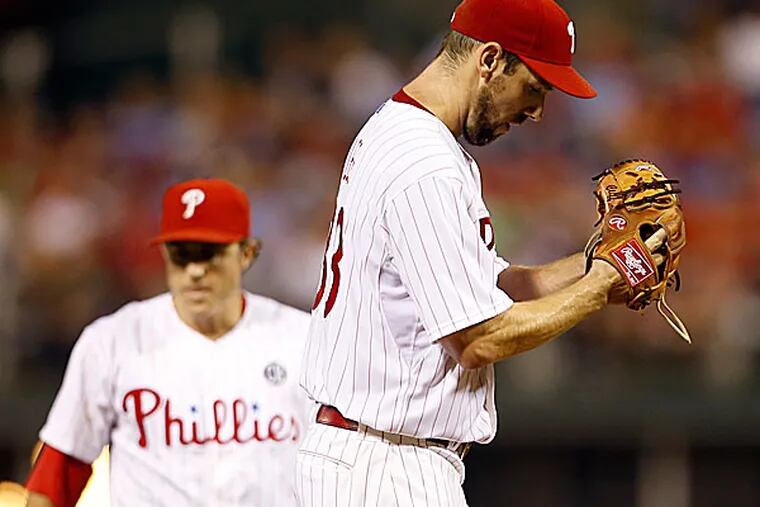 Phillies second baseman Chase Utley and starting pitcher Cliff Lee. (Yong Kim/Staff Photographer)