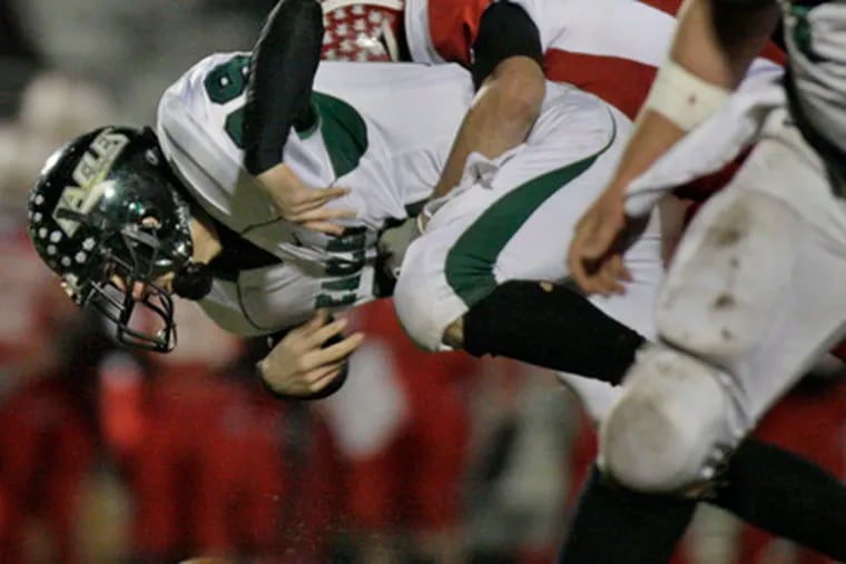 West Deptford&#0039;s Rob Fearon watches the ball pop loose as he is hit by Delsea&#0039;s Dylan Wilton.
