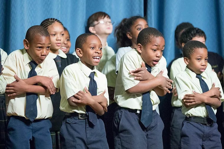 Third and fourth graders at St. Francis de Sales Catholic school in West Philadelphia go through a series of warm-up drills before performing. They're participating in a visiting artists program by the Wolf Performing Arts Center.