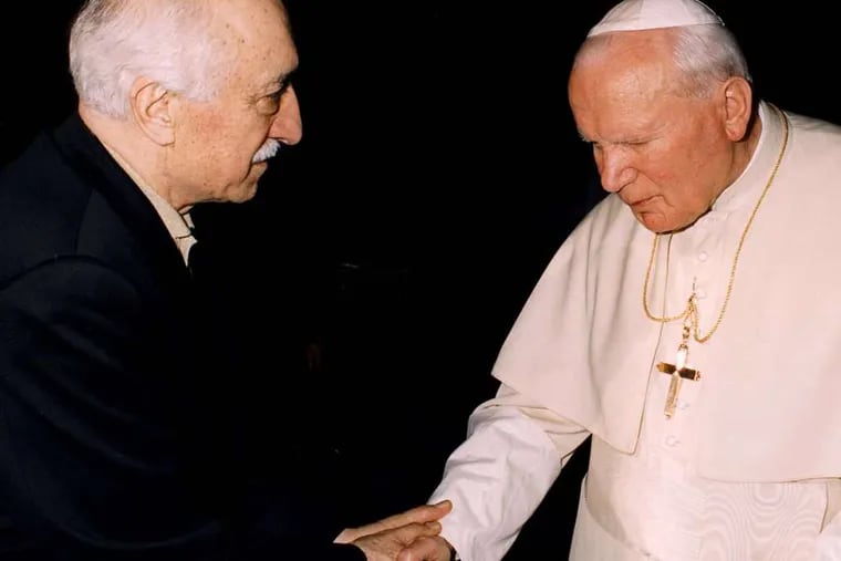 Turkey's Muslim spiritual leader M. Fetullah Gulen (left), shook hands with Pope John Paul II when they meet at the Vatican in 1998.