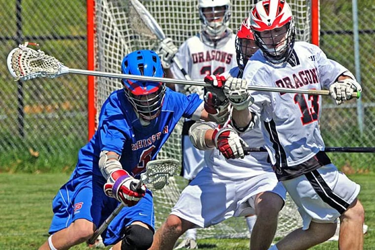 Washington Township's Alex Dennery takes on Kingsway's Trevor Elm in a boys' lacrosse game on Saturday, May 4th, 2013.(April Saul / Staff Photographer)