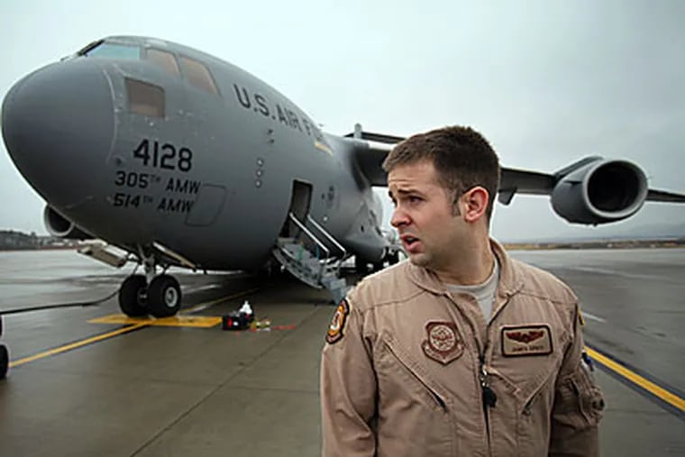 Captain James Sprys with the Air Force C17 cargo jet at Ramstein Air Base in Germany during the crew's mission to deliver supplies to Afghanistan. (Laurence Kesterson / Staff Photographer)